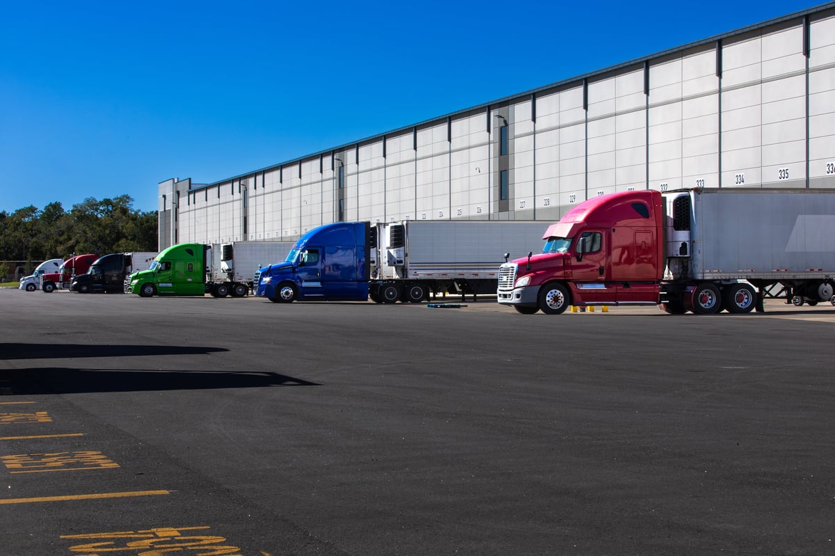 Semi trucks parked on a warehouse loading dock